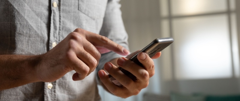 Decorative image - Man clicking on mobile phone