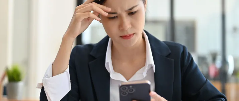 Decorative image - Woman concerned looking at mobile phone