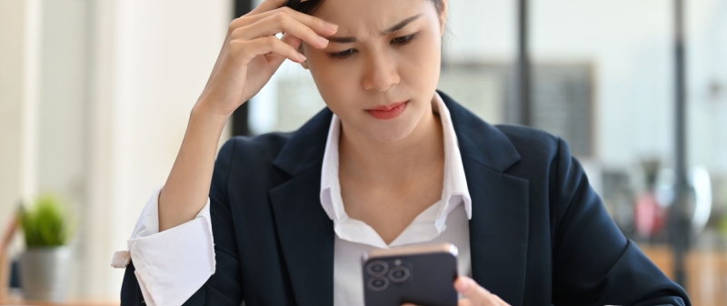 Decorative image - Woman concerned looking at mobile phone