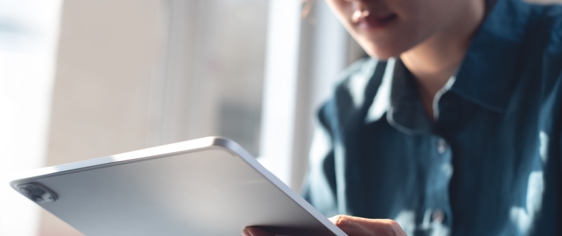 Decorative image - Person reading online on tablet