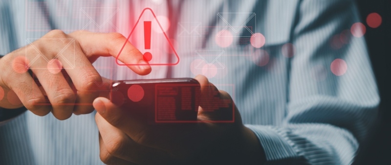Decorative image - Person receiving warning about potential scam text on phone