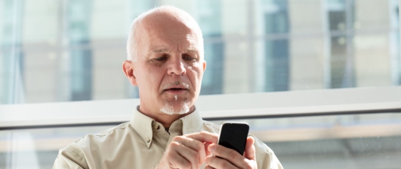 Decorative image - Man dialling a number on phone