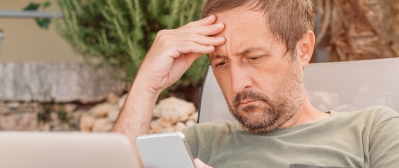 Decorative image - Concerned man looking at phone