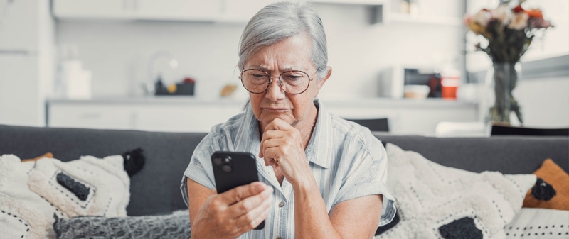 Decorative image - Woman looking at phone perplexed