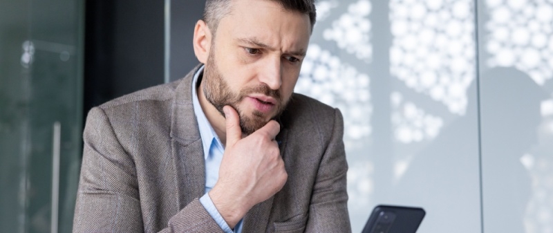 Decorative image - Concerned business man looking at phone