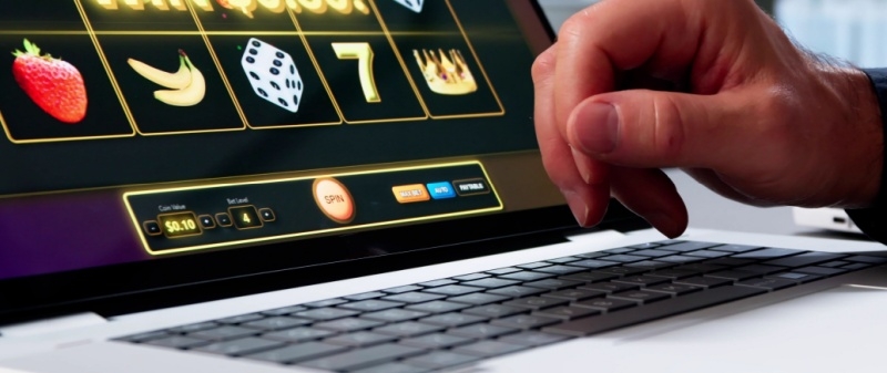 Decorative image - Person playing online poker on laptop