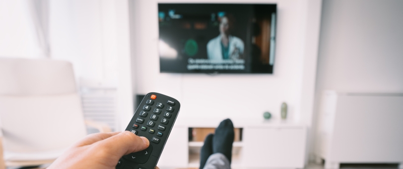 Decorative image - Person watching TV with subtitles