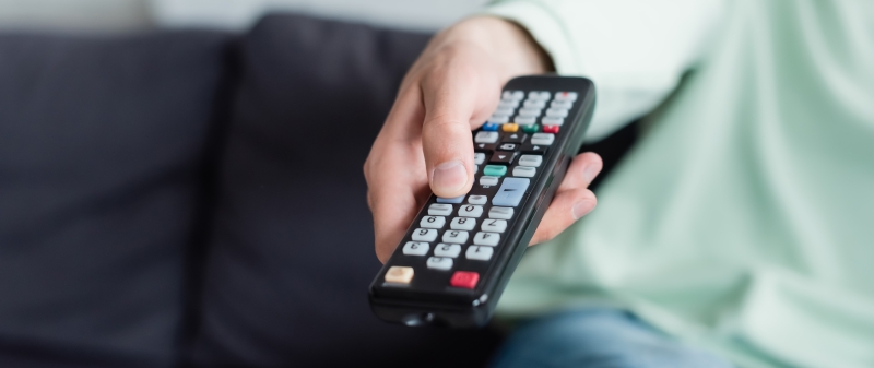 Decorative image - Woman holding TV remote