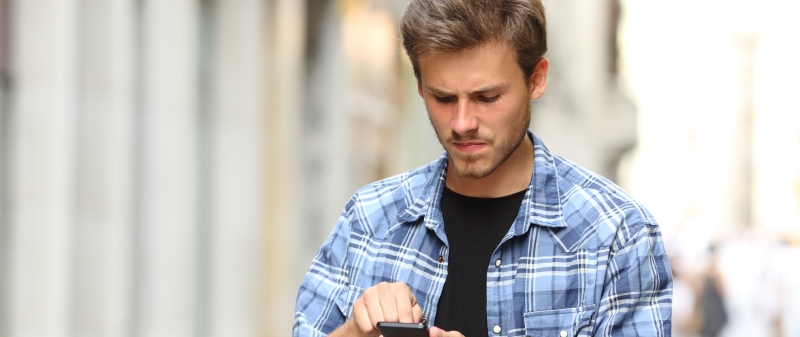 Decorative image - Concerned young man scrolling on phone
