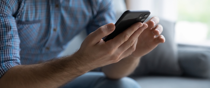 Decorative image - Man scrolling on mobile phone