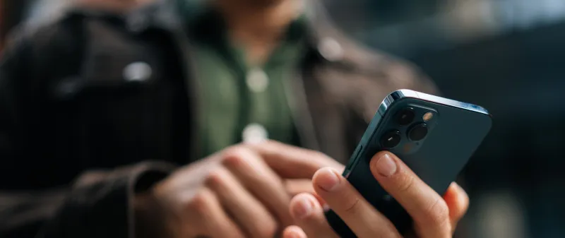 Decorative image - Man navigating screen on mobile phone