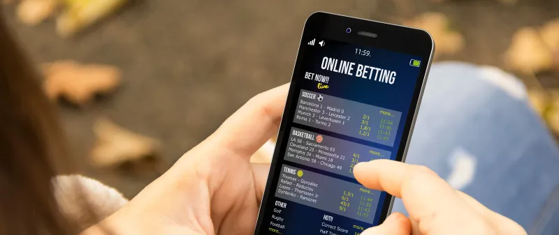 Decorative image - Person doing online betting on phone