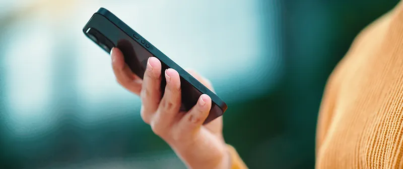 Decorative image: Person using a mobile phone