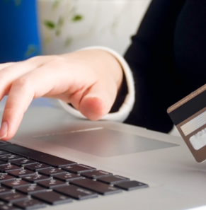 Decorative image - Person using laptop holding credit card