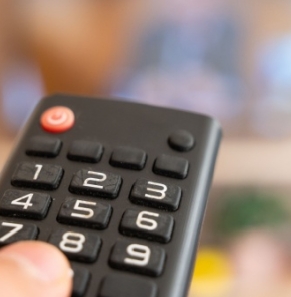 Decorative image - Person pointing remote control at TV