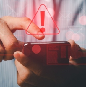 Decorative image - Person receiving warning about potential scam text on phone