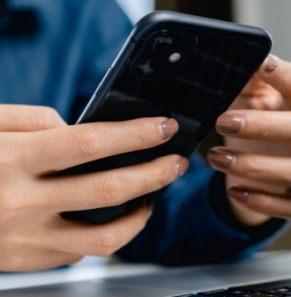 Decorative image - Woman using mobile phone and laptop