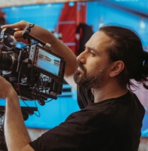 Decorative image - Cameraman adjusting camera