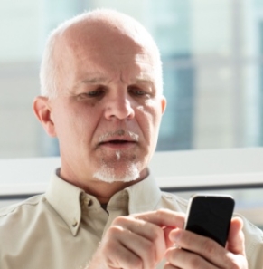 Decorative image - Man dialling a number on phone