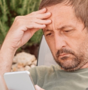 Decorative image - Concerned man looking at phone