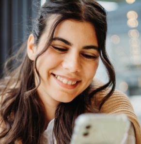 Decorative image - Happy woman looking at mobile phone