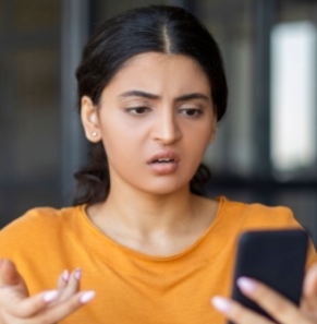 Decorative image - Annoyed woman looking at mobile phone