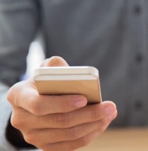 Decorative image - Man using mobile phone holding credit card