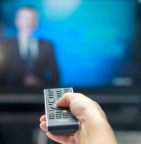 Decorative image - Woman with remote control watching TV