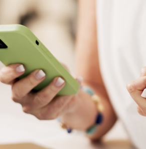 Decorative image - Person holding credit card and looking at mobile