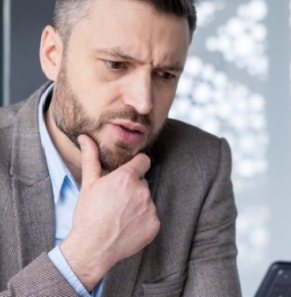 Decorative image - Concerned business man looking at phone