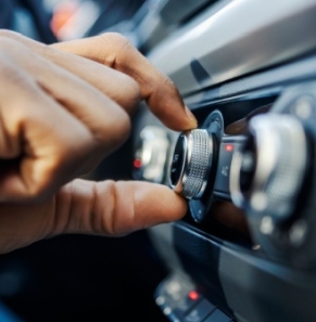 Decorative image - Person adjusting radio in car