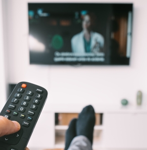 Decorative image - Person watching TV with subtitles