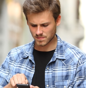 Decorative image - Concerned young man scrolling on phone