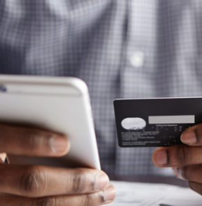 Decorative image - Man holding credit card and mobile phone