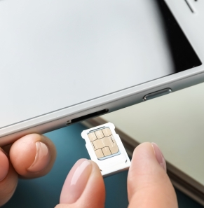 Decorative image - Woman inserting SIM card into phone