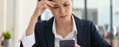 Decorative image - Woman concerned looking at mobile phone