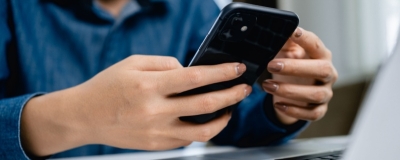 Decorative image - Woman using mobile phone and laptop