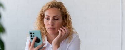 Decorative image - Concerned woman looking at mobile phone