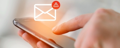 Decorative image - Person receiving text message with warning symbol