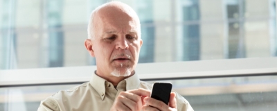 Decorative image - Man dialling a number on phone