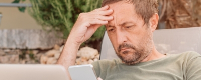 Decorative image - Concerned man looking at phone