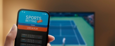 Decorative image - Person betting on phone during live tennis match