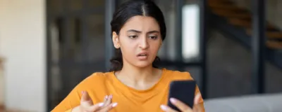 Decorative image - Annoyed woman looking at mobile phone