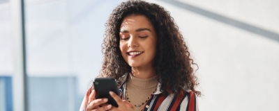 Decorative image - Happy woman looking at phone