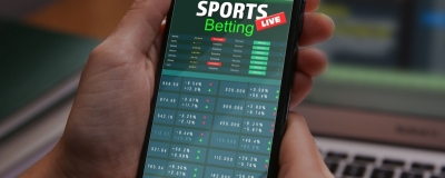 Decorative image - Person betting on phone