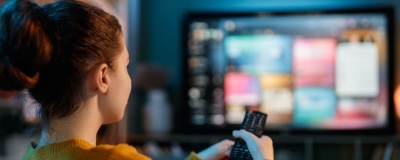 Decorative image - Woman watching TV streaming service