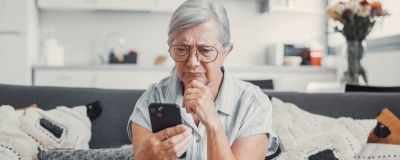 Decorative image - Woman looking at phone perplexed