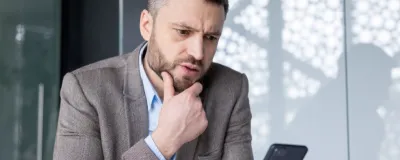 Decorative image - Concerned business man looking at phone