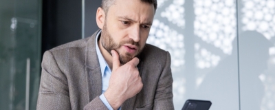 Decorative image - Concerned business man looking at phone