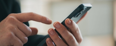 Decorative image - Person looking at content on mobile